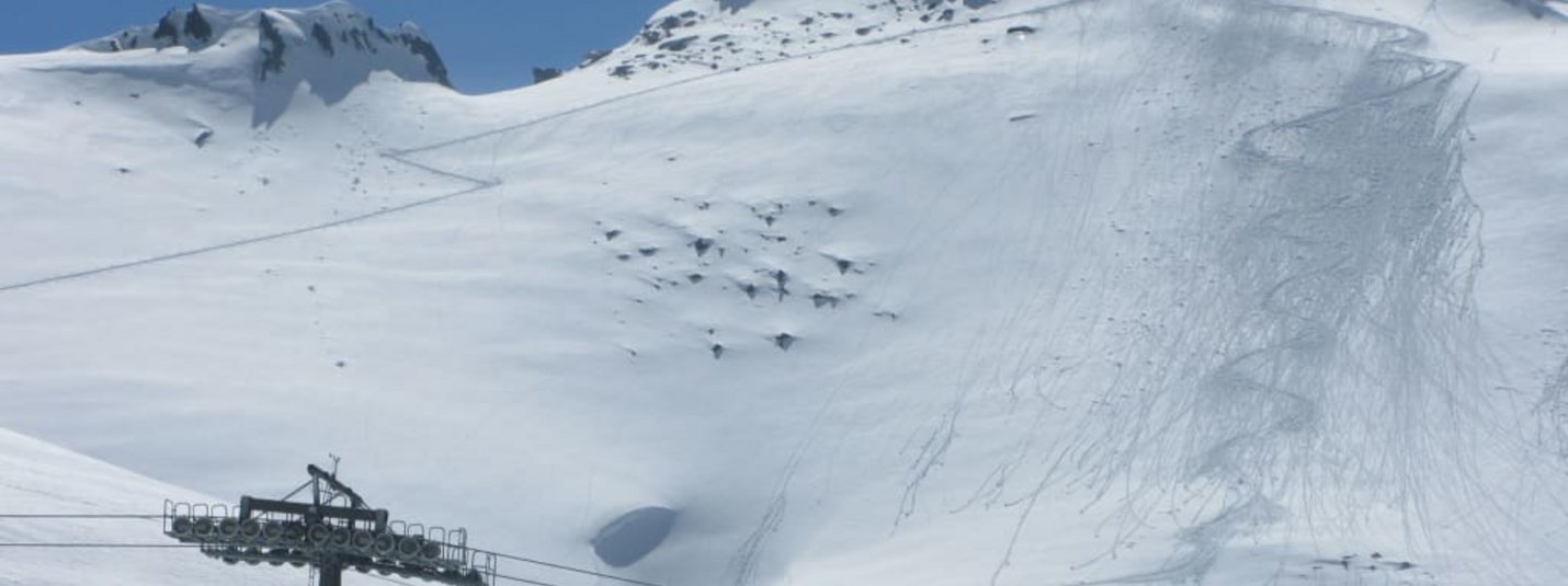 Skiopening 3 Tage - Sonntagsanreise Seilbahn und schneebedeckte Alpen mit Skispuren unter blauem Himmel