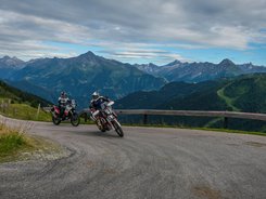 Zillertal – Gerlos Alpenstraße © Moppetfoto.de Zwei Motorradfahrer fahren auf Bergstraße mit Alpen im Hintergrund