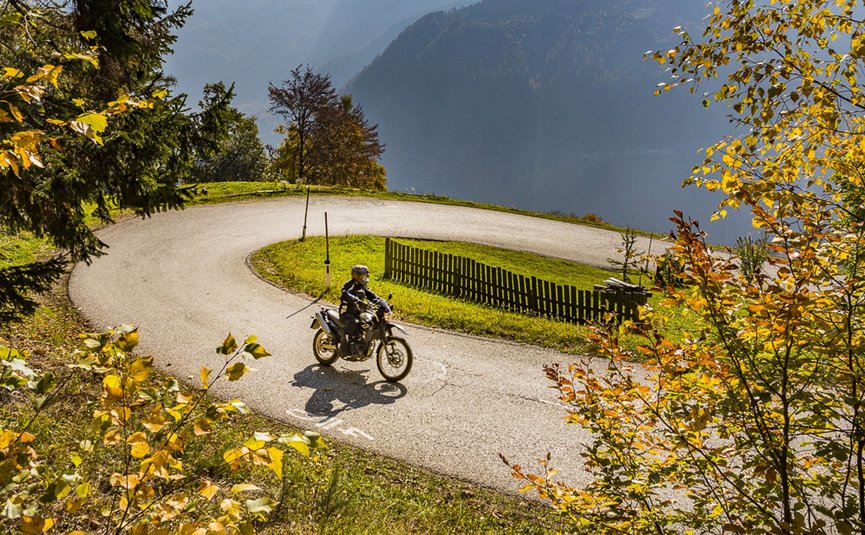Motorradurlaub in Südkärnten – Karawanken – Slowenien © Alexander Seger Motorradfahrer fährt durch eine kurvige Straße im herbstlichen Bergwald